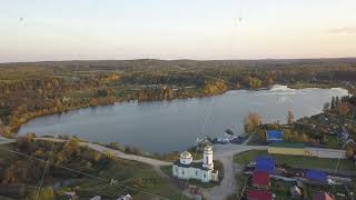 Aerial cityscape skyline view of village town, church and beautiful river gulf during day. Beautiful