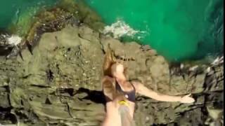 Jumping Backflip  Woman In Bikini  Athletic Young Woman Jumping From Cliff Int