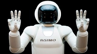 Роботы ASIMO танцуют.