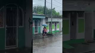 Girl Falls Trying to Carry Another While Crossing Street With Strong Current