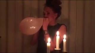 Girl blows to pop a Balloon on her Birthday