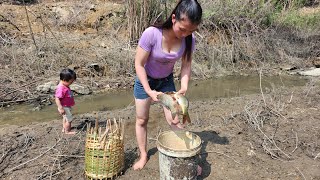 catching fish in the stream for food - a single mother and child