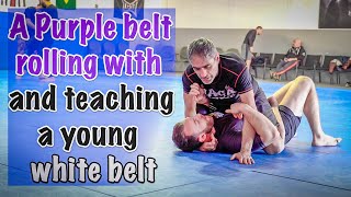 A purple belt rolling lesson with a white belt