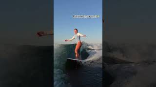 Woman is wakesurfing on the KR pro skim from Jackpine wakesurf boards!