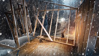 The first snow fell. The skeleton of the house is completely finished. House in the wild forest.