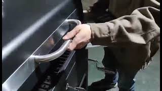 Adjusting The Lid of The Charcoal Grill