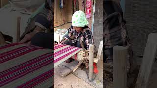 A craftsman is demonstrating an ancient weaving technique