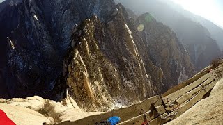 Daredevil Tourists Snap Dizzying Selfies from a Wobbly Plank Above a 7,000ft at China's Mount Hua