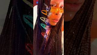 Erykah Badu sporting custom lighter hair clips and lighter sunglasses