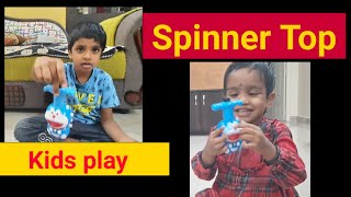 Cute kids playing with Spinner Top Kids play Funtime