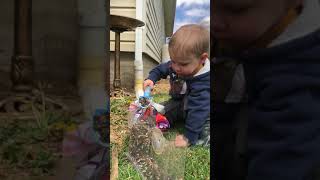 Thomas filling the bird feeder