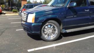 2005 Cadillac Escalade sitting on 22" DCenti DW706 Chrome Wheels And 305/45-22 Lexani Tires.