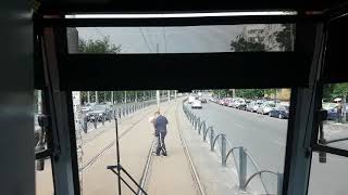 Man on Bucharest tram track and tram stops